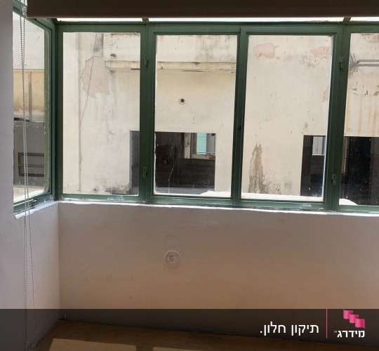 חלון זכוכית עם שלט על מדף עץ
